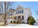 Two-story house with brick and siding exterior, attached garage, and front porch at 3460 Limelight Ln, Whitestown, IN 46075
