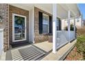 Inviting front porch with brick columns and white railing at 3460 Limelight Ln, Whitestown, IN 46075