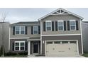 Charming two-story home with a two-car garage and black shutters at 371 Traditions Pass, Greenwood, IN 46143