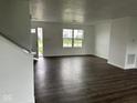 Bright living room with dark wood floors and large windows at 371 Traditions Pass, Greenwood, IN 46143