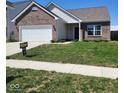 Charming single-story home with brick accents, a well-manicured lawn, and a 'Tucker' sign at 5154 Bramwell Ln, Whitestown, IN 46075