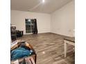 Large living area with wood-look tile flooring and sliding glass doors at 5154 Bramwell Ln, Whitestown, IN 46075