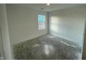 Bedroom with neutral walls, natural light and concrete floors at 6636 Sulgrove Pl, Indianapolis, IN 46221