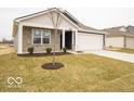 Single-story house with a two-car garage, lawn, and landscaping at 6636 Sulgrove Pl, Indianapolis, IN 46221