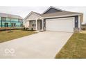 Single-story home with a two-car garage and long concrete driveway, situated on a grassy lawn at 6636 Sulgrove Pl, Indianapolis, IN 46221