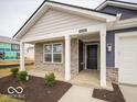 Charming front porch with columns and landscaping at 6636 Sulgrove Pl, Indianapolis, IN 46221