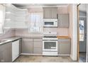 Updated kitchen featuring granite countertops and modern appliances at 704 S Ohio St, Sheridan, IN 46069