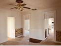 Living room featuring original trim work and a ceiling fan with vintage accents and a view to the kitchen at 704 S Ohio St, Sheridan, IN 46069
