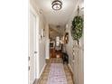 Inviting foyer with tile flooring and view into the living room featuring a fireplace at 8104 Pocket Hollow Ct, Indianapolis, IN 46256