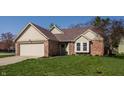 Inviting home featuring a brick facade, two-car garage, and manicured front lawn at 8104 Pocket Hollow Ct, Indianapolis, IN 46256