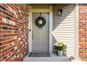 Welcoming front entrance with a gray door, wreath, and a decorative flower pot at 8104 Pocket Hollow Ct, Indianapolis, IN 46256