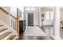 Bright and spacious entryway with dark hardwood floors and staircase at 8526 Oakmont Ln, Indianapolis, IN 46260