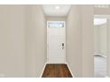 Bright entryway featuring a white front door with transom window and sleek wood-look flooring at 9711 Palermo Ave, Indianapolis, IN 46239