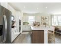 Open concept kitchen with white cabinets, large island, and stainless steel appliances at 9711 Palermo Ave, Indianapolis, IN 46239