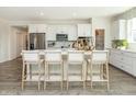 Spacious kitchen with white cabinets, island, stainless steel appliances, and hardwood floors at 9711 Palermo Ave, Indianapolis, IN 46239