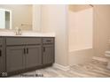 Bathroom with gray vanity, white tub and shower, and gray tile floor at Lot 34 Doe Meadow Dr, Anderson, IN 46011