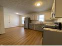 Modern kitchen with stainless steel appliances and light grey cabinets at 1608 Edgecombe Ave, Indianapolis, IN 46227