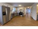 Modern kitchen with stainless steel appliances and light grey cabinets at 1608 Edgecombe Ave, Indianapolis, IN 46227