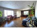 Spacious living room with hardwood floors and lots of plants at 1683 W State Road 42, Mooresville, IN 46158