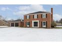 Attractive brick home with 2-car garage and a snowy front yard at 1716 Westwood Dr, Anderson, IN 46011