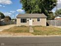 Tan house with a white door, small yard, and driveway at 2606 13Th St, Columbus, IN 47201