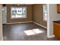 Living room, hardwood floors, neutral walls, and kitchen view at 2606 13Th St, Columbus, IN 47201