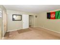 Living room with tan carpet and walls, featuring a large window and door at 3153 Arbutus Dr, Indianapolis, IN 46224
