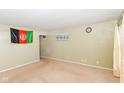 Living room with tan carpet and walls, featuring a large window and door at 3153 Arbutus Dr, Indianapolis, IN 46224