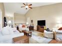 Bright living room featuring vaulted ceilings, hardwood floors, comfortable seating, and a ceiling fan at 4343 Raintree Blvd, Greenwood, IN 46143