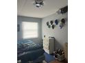 Bedroom with a bed, dresser, and various hats on the wall at 4715 E 33Rd St, Indianapolis, IN 46218