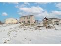 Spacious backyard with a playset and snow-covered ground at 507 Abbywood Cir, Danville, IN 46122