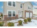 Two-story house with beige siding, brick accents, and a partially visible front porch at 507 Abbywood Cir, Danville, IN 46122