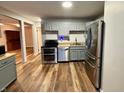 Modern kitchen with gray cabinets, stainless steel appliances, and wood-look floors at 5617 Yucatan Dr, Indianapolis, IN 46237