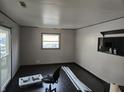 Minimalist bedroom features a large window, dark hardwood floors, and neutral walls at 604 Gooseberry Ln, Greenwood, IN 46143