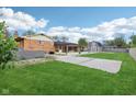 Spacious backyard featuring a large lawn, patio, and an outbuilding at 6327 E 52Nd Pl, Indianapolis, IN 46226