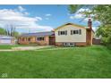 A two-story home boasts a combination of brick and vinyl siding, complemented by a well-maintained green lawn at 6327 E 52Nd Pl, Indianapolis, IN 46226