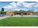 Backyard view of the sunroom with multiple windows at 6327 E 52Nd Pl, Indianapolis, IN 46226
