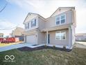 Two-story home features gray siding, a brick facade, a two-car garage, and a well-maintained lawn at 6349 Granby Dr, Whitestown, IN 46075