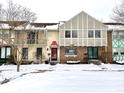 Charming townhouses featuring unique architectural details and snow-covered landscaping at 8104 Cheswick Dr, Indianapolis, IN 46219