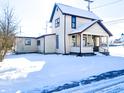 Two-story house with a snow covered yard at 107 E Garfield St, Alexandria, IN 46001