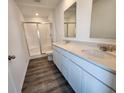Bathroom features a double vanity with framed mirrors and a walk-in shower with glass doors at 11275 N Quillow Way, Monrovia, IN 46157
