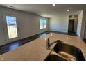 Modern kitchen featuring an island with a stainless steel sink, quartz countertop and open floor plan at 11275 N Quillow Way, Monrovia, IN 46157