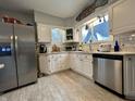 Bright kitchen featuring white cabinets, stainless steel appliances, and granite countertops at 1203 W 8Th St, Anderson, IN 46016