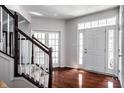 Home foyer featuring beautiful wood floors, white staircase and lots of natural light at 12596 Autumn Gate Way, Carmel, IN 46033