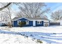 Blue house exterior, winter scene with snow at 1305 Woodbine Dr, Anderson, IN 46011