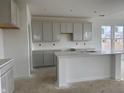 Bright kitchen featuring shaker cabinets, quartz countertops, and a spacious island at 13359 Vickery Ridge Dr, Fishers, IN 46037