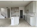 Bright kitchen featuring shaker cabinets, quartz countertops, and a spacious island and a staircase at 13359 Vickery Ridge Dr, Fishers, IN 46037