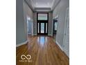 Grand foyer featuring hardwood floors and an elegant front door at 13650 Golden Ridge Ln, Fishers, IN 46055