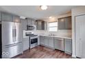 Modern kitchen with gray cabinets, stainless steel appliances, and marble countertops at 1715 Danielle Rd, Lebanon, IN 46052