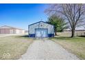 Detached garage with gravel driveway and open field views at 1733 N Buck Creek Rd, Greenfield, IN 46140